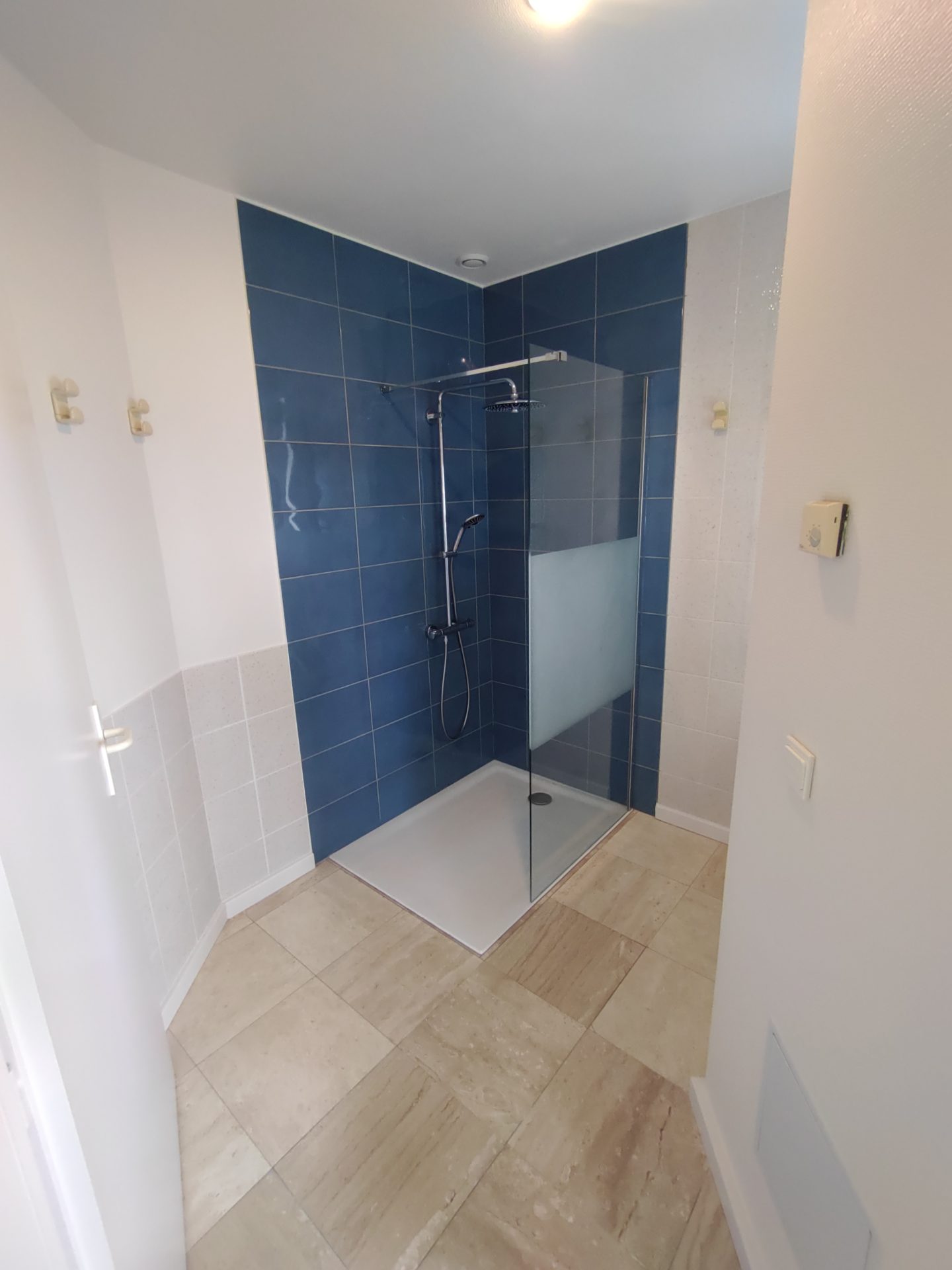 Design original avec faïence et paroi de douche bleues, pour une rénovation de salle de bain personnalisée par l'artisan Jimmy Paul à Billère.